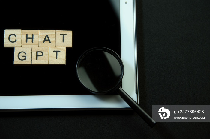 Chat GTP written in wooden letters and a magnifying glass.