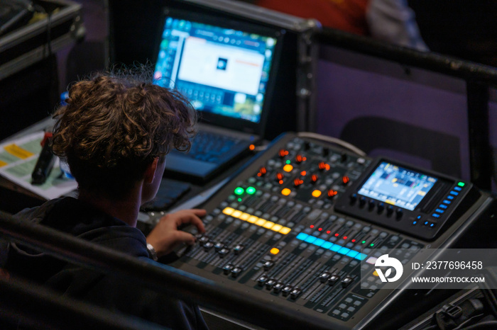 Sound engineer using laptop during work