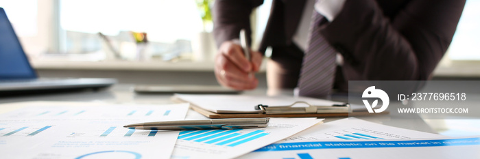 Silver pen lie at important paper on table in office