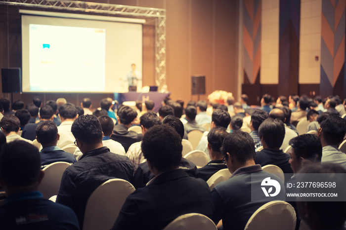 Clouds listening to the Speakers on the stage with Rear view of Audience in the conference hall or seminar meeting, business and education about investment concept