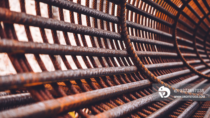 Iron on construction site. Circle Iron Bundle for making reinforcement concrete and plastic orange net. Inside view of rebar for reinforced hole in the ground. Texture