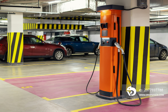 Electric car fast charging station at indoor underground parking. Power supply point network for hybrid electric car charging battery. Eco green energy