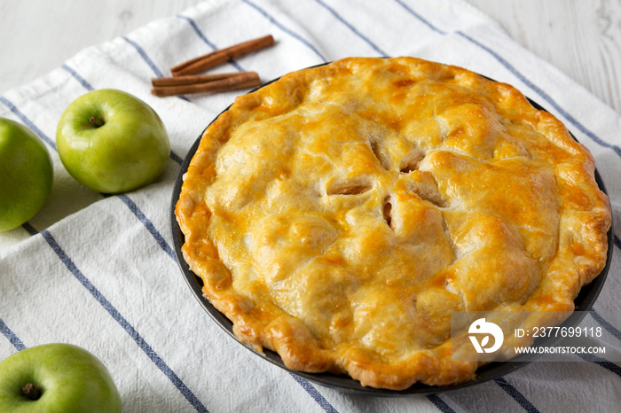 Homemade apple pie on cloth, side view. Close-up.