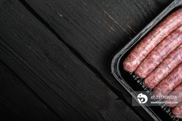 Fresh Polish Sausages pack, on black wooden table background, top view flat lay, with copy space for text