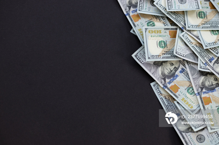 Top view of bundle of 100 dollar bill on black background. Business concept with copy space