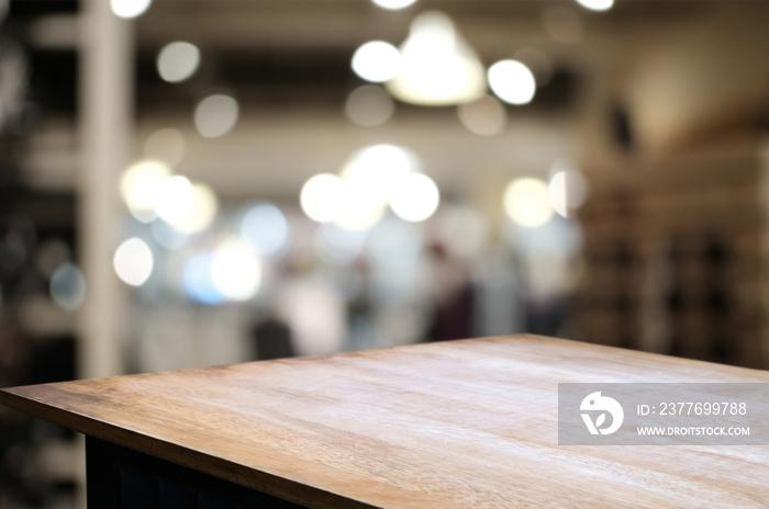 wood table in front of blur super market background.