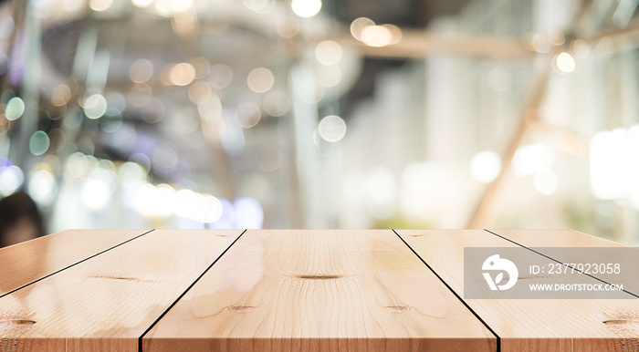 Empty wooden table top with lights bokeh on blur restaurant background