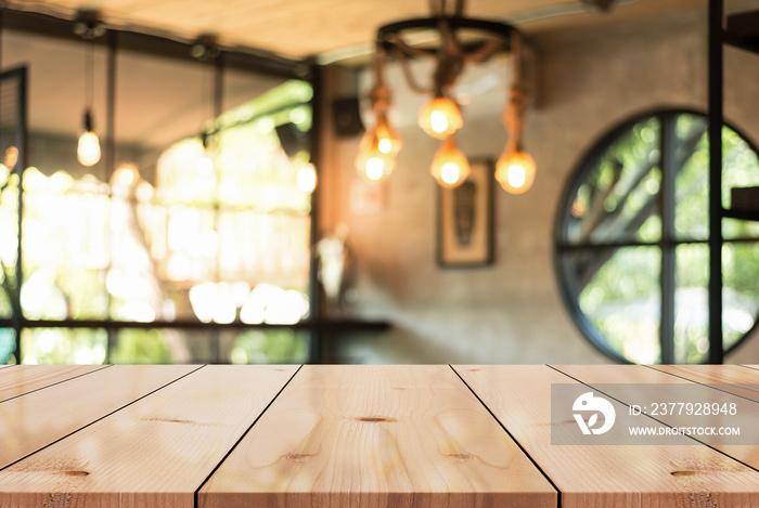 Empty wooden table top with lights bokeh on blur restaurant background