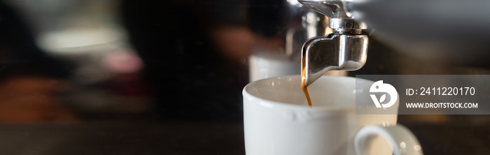 Coffee machine and ceramic white coffee cup in a cafe. Promotional poster and making Americano coffee. Professional coffee equipment.