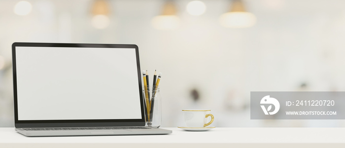 Laptop computer blank screen mockup on tabletop with copy space over blurred background