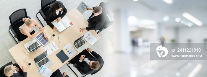 Business people group meeting shot from top widen view in office . Profession businesswomen, businessmen and office workers working in team conference with project planning document on meeting table .