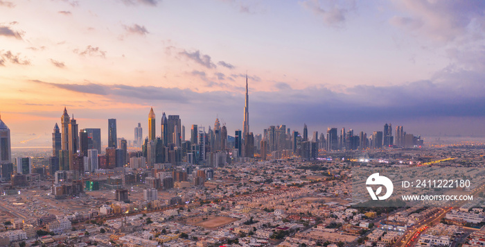 Aerial view of Burj Khalifa in Dubai Downtown skyline and highway, United Arab Emirates or UAE. Financial district and business area in smart urban city. Skyscraper and high-rise buildings at sunset.