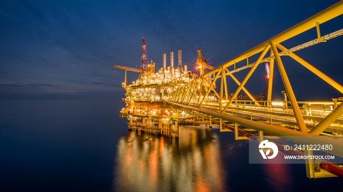 Industrial Offshore oil and gas rig platform at night in the gulf of Thailand.