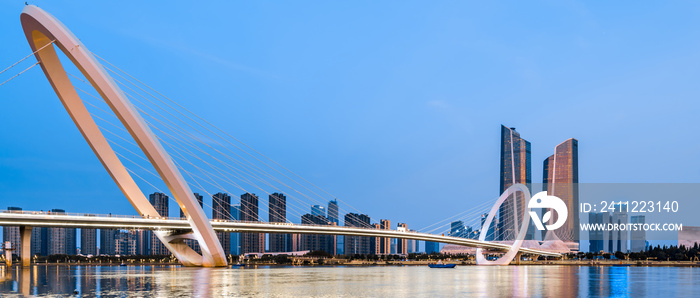 Night view of city skyline of Nanjing Eye Bridge and Poly Theater in Nanjing, Jiangsu, China