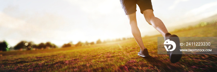 panoramic - man running marathon through the field