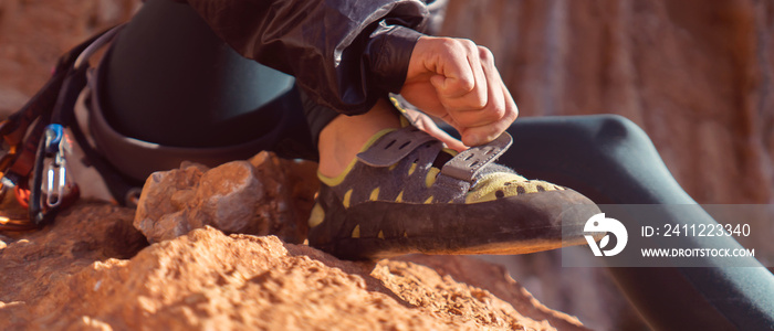 Girl is wearing climbing shoes, closeup view.