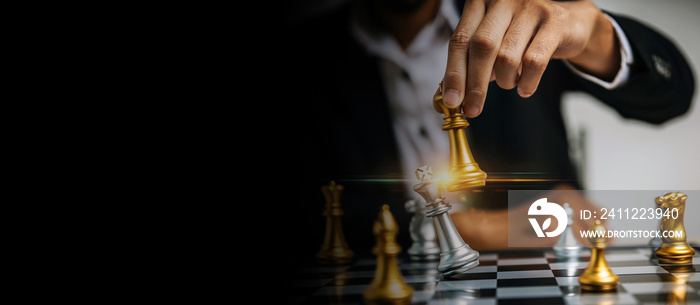 wide banner. businessman hand moving golden chess on chess board game competition, chess battle, business management, leadership success, team leader, teamwork, business strategy planning concept