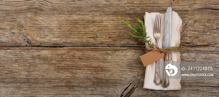 Table setting with tag on wooden background