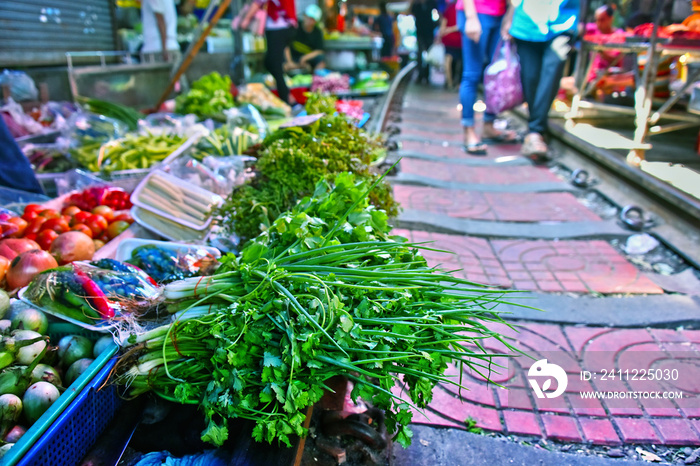 Selling food on the Maeklong Railway market in Thailand