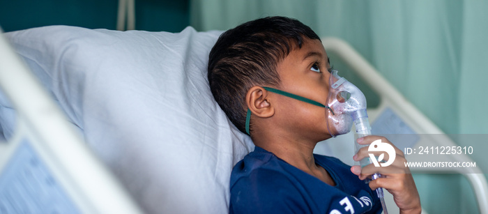 Muslim Boy with his nebuliser. Asthma treatment. Soft focus, shallow depth of field