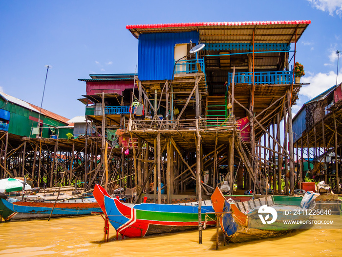 Traditional Kampong Phluk floating village with multicolored boats and stilt houses, Tonle Sap lake, Siem Reap Province, Cambodia