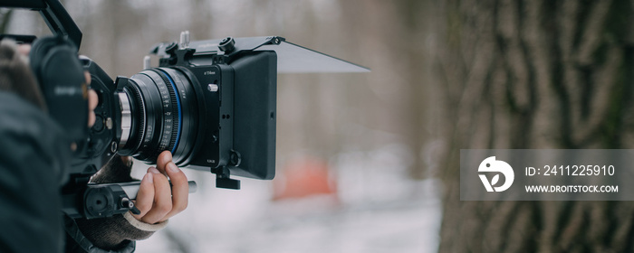 Professional cinema and video camera on the set. Shooting shift, lighting fixtures, shooting equipment and the team. Technique of modern filming and advertising.