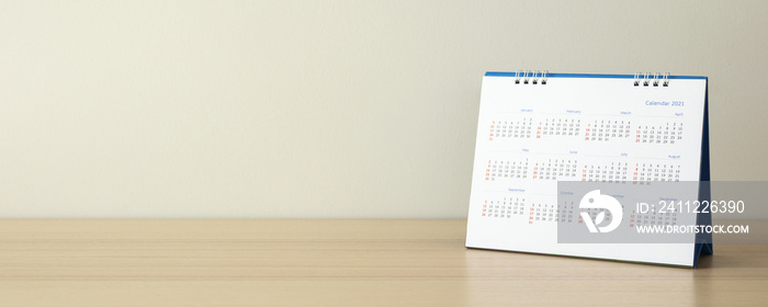 Calendar page close up on wood table with white wall background business planning appointment meeting concept