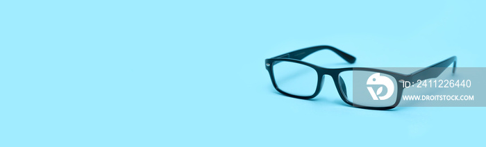 Glasses on a blue background, copy space