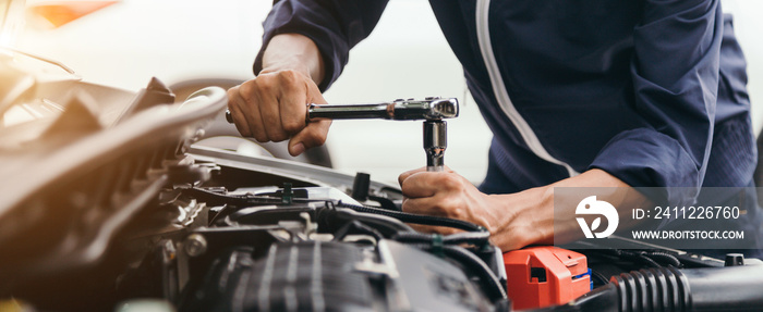 Automobile mechanic repairman hands repairing a car engine automotive workshop with a wrench, car service and maintenance,Repair service.