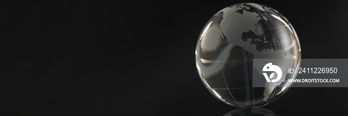 Glass globe on a black background, reflection of a circle