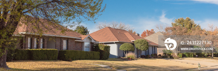 Panoramic single story bungalow houses in suburbs of Dallas with bright fall foliage colors