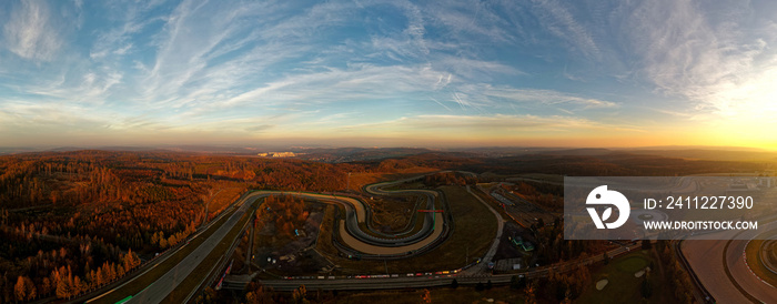 Landscape with the Automotodrom Racing circuit in Brno, Grand Prix of motorbikes and cars in the Czech republic. Panoramic view from the air during sunset