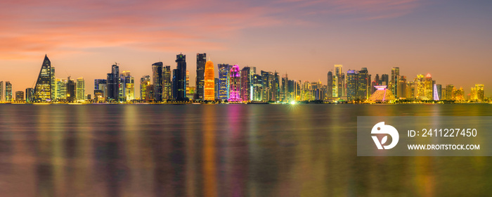 Long exposure panorama shot of Doha city skylines illuminated at night in Doha, Qatar