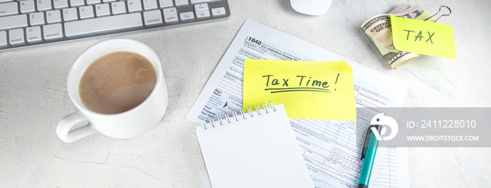 Banner with Tax time - Notification of need to file tax returns, tax form at accountant’s workplace. Top view of notepad, stickers, cup of coffee