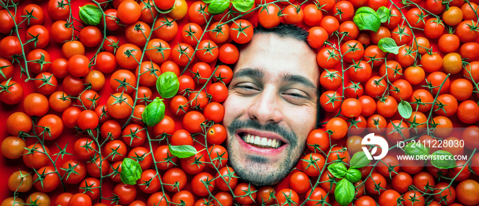 Man with tomatoes , concept for the food industry. Face of laughing men in the tomatoes surface. No plastic packaging concept