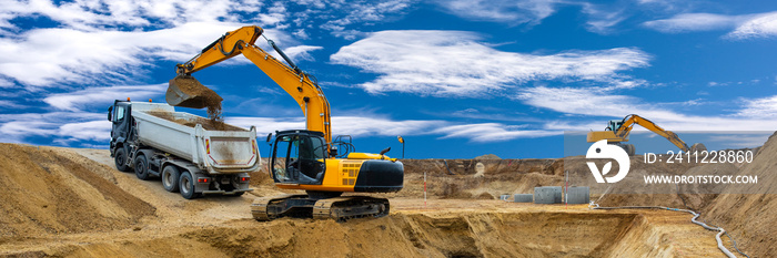 excavator working on construction site with dramatic clouds on sky