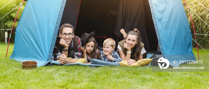 Family having fun camping in their house garden