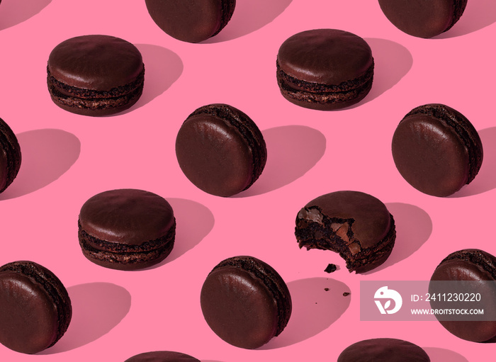 Chocolate macarons pattern in a pink background