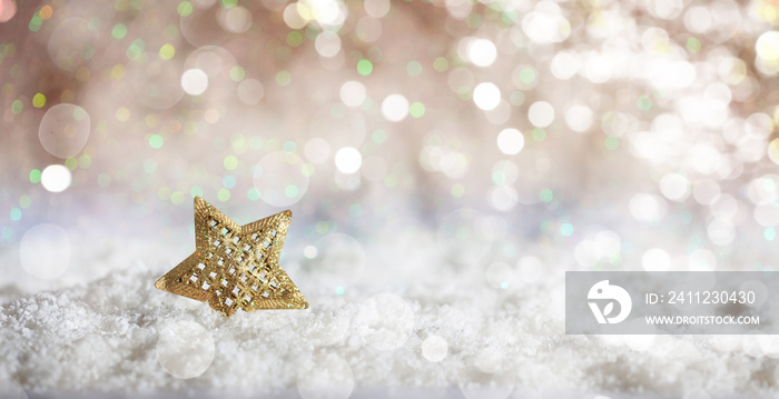 Golden star on Christmas snowy bokeh background