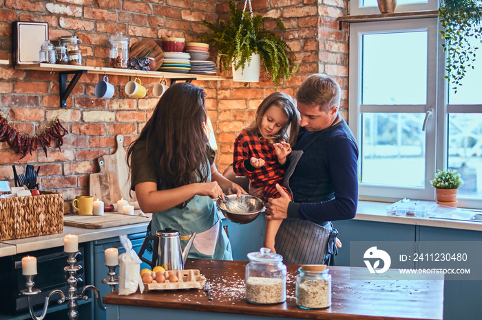 Family together cooking breakfast in loft style kitchen.