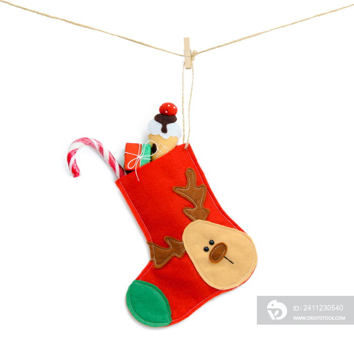 Christmas red sock with sweets isolated on a white background. Ornament deer, handmade