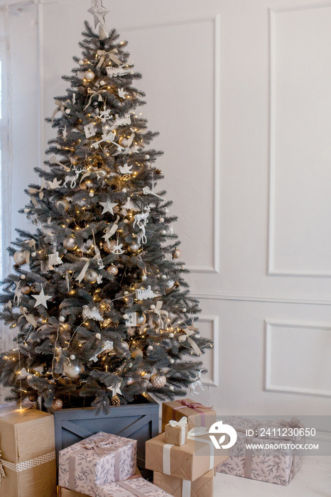 Beautifully decorated Christmas tree with many presents under it.