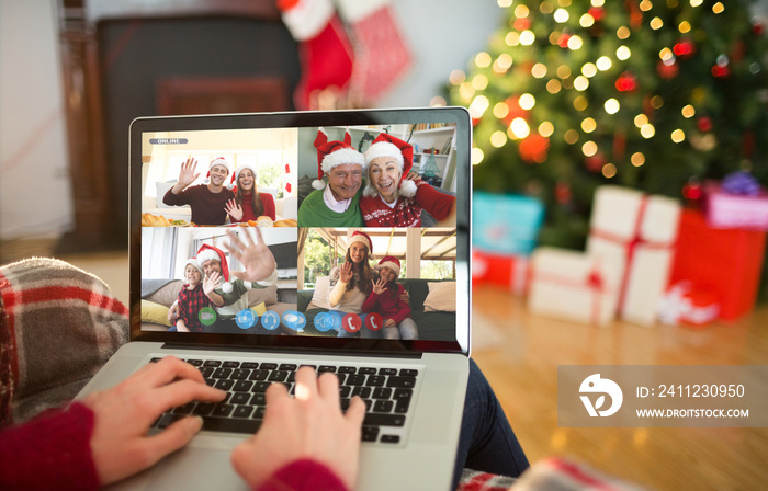 Caucasian woman making christmas laptop video call with waving friends and family