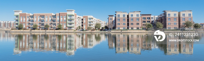Riverside apartment building complex reflection blue sky