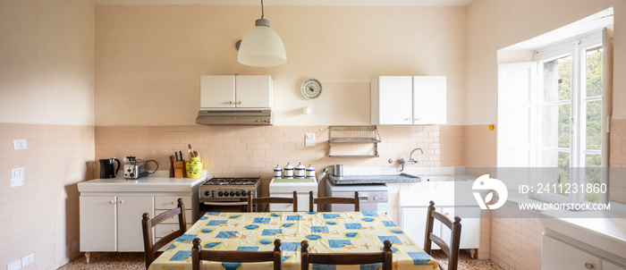 Interior of a large Italian country kitchen. Nobody inside. Frontal view