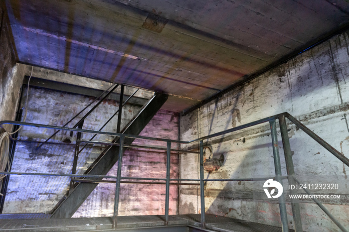 Industrial metal staircase in the old factory. Illuminated