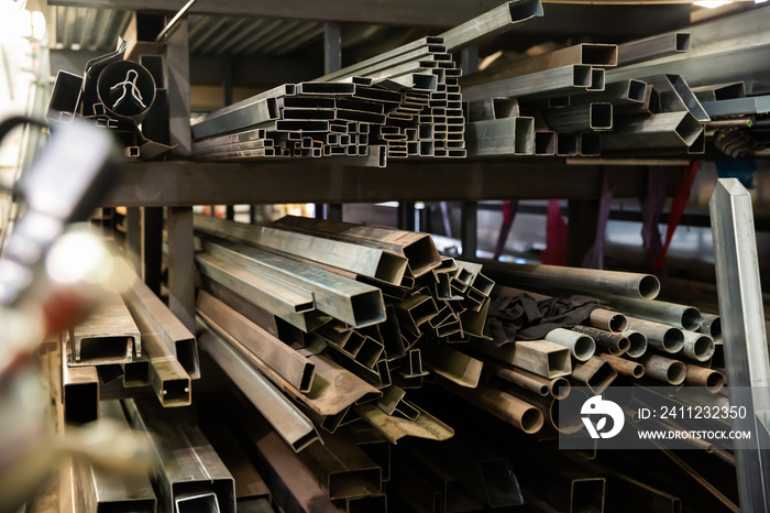 Metal profile of the pipe lies on the shelves in the workshop. High quality photo