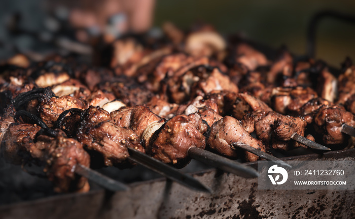 Grilling shashlik on barbecue grill