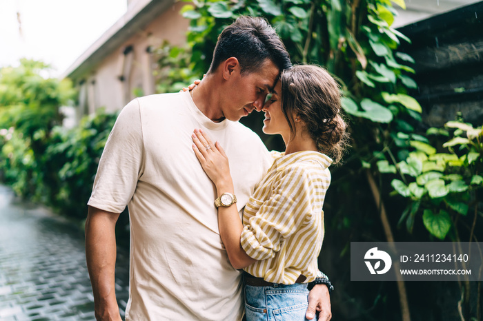 Loving couple hugging each other while standing on street