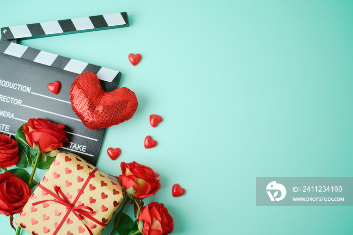 Valentines day background with movie clapper board, heart shapes and gift box. Romantic movie concep